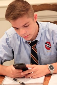 distracted teen looking at phone